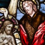 Depicts a detailed stained glass artwork featuring biblical scenes in vivid colors.