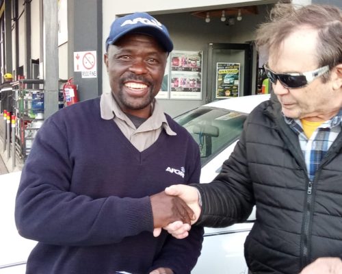 man receiving bible from pastor