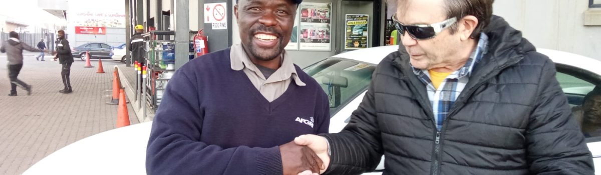 man receiving bible from pastor